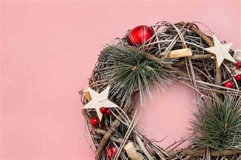 Premium Photo | Christmas wreath on pink