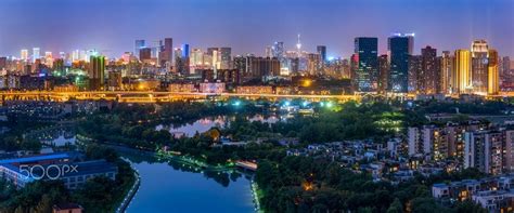 Chengdu city skyline panorama at night with a river in the foreground - Chengdu city skyline ...