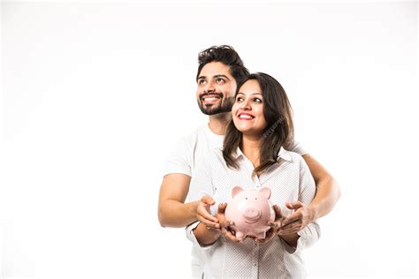 Premium Photo | Indian couple with piggy bank standing isolated over white background