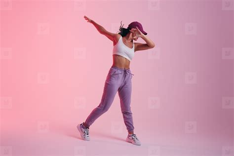 Young woman doing the dab dance move in a studio stock photo (259175 ...