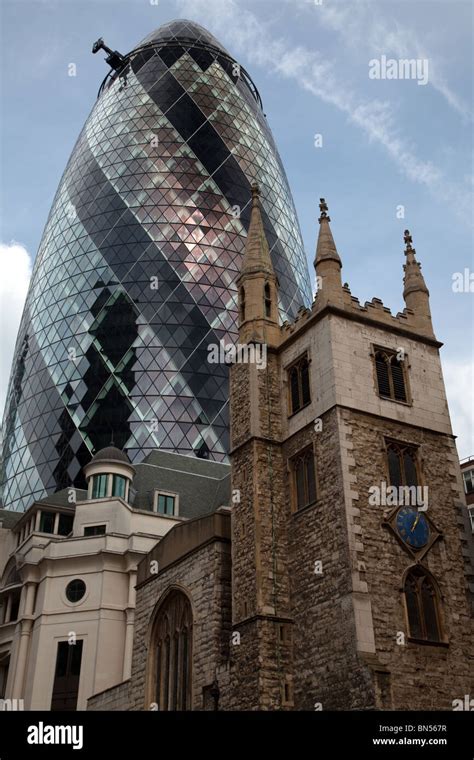 View of 'The Gerkin' building in London behind old church Stock Photo ...