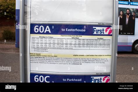 Glasgow First Bus timetable with a blurred bus in the background Stock Photo - Alamy