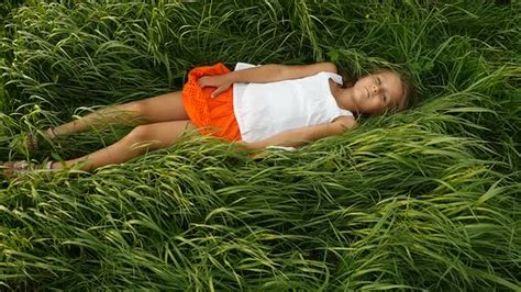 Little Girls Resting on the Green Grass. Beautiful Kids Lying on the Field, Stock Footage