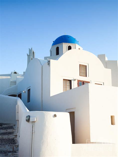 White buildings and blue church in Oia Santorini Greece Photograph by Matteo Colombo - Fine Art ...