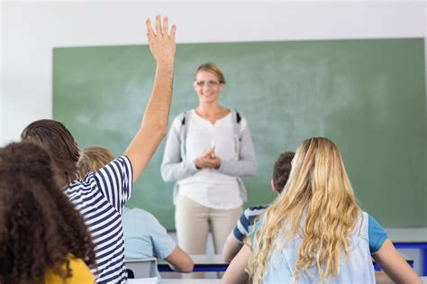 Premium Photo | Student raising hand in classroom