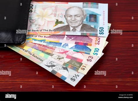 Bahamian dollar in the black wallet Stock Photo - Alamy