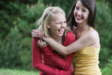 Girls laughing in park - Stock Photo - Dissolve