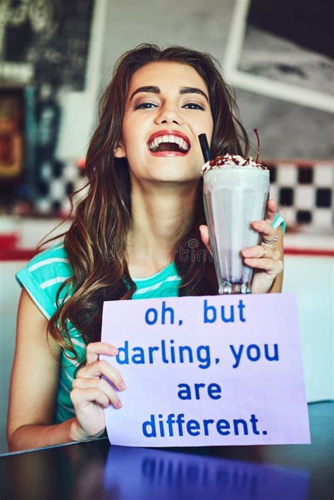 Stand Out. an Attractive Young Woman Holding Up a Sign while Enjoying a Milkshake in a Retro ...
