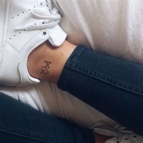 Small tattoo of Rune symbols M and O, meaning M = Mannaz = the self, mankind, friends and ...