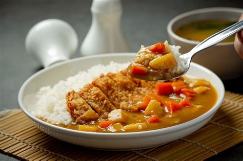 Premium Photo | Fried pork cutlet curry with rice on dark surface