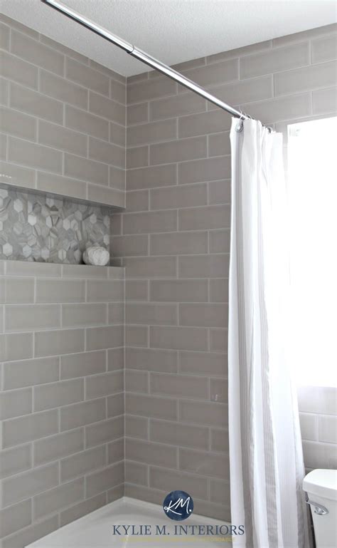 Gray subway tile shower surround with niche or alcove in hexagon shape marble tile for an accent ...