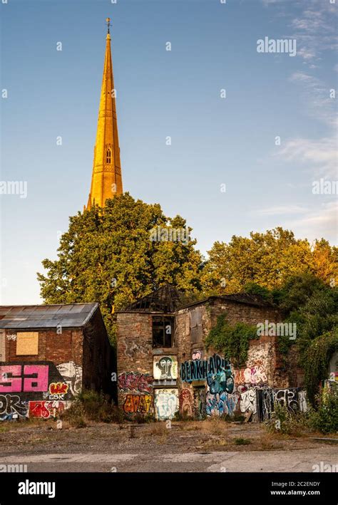 The tall spire of St Mary Redcliffe Church rises behind derelict and burnt out industrial ...