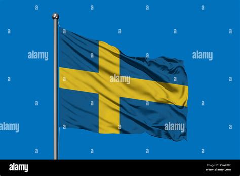 Flag of Sweden waving in the wind against deep blue sky. Swedish flag ...