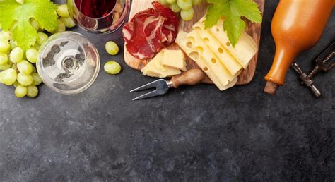 Premium Photo | White and red wine glasses grape and appetizer board