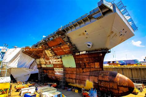 the large ship is being worked on in the shipyard