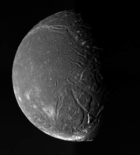 Titania, moon of Uranus, is photographed by the Voyager 2 space probe ...