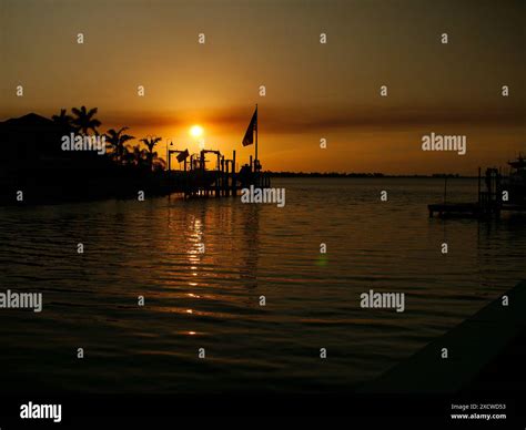 Sunset Silhouette of US Flag looking NW Boca Ciega Bay near bridge at ...