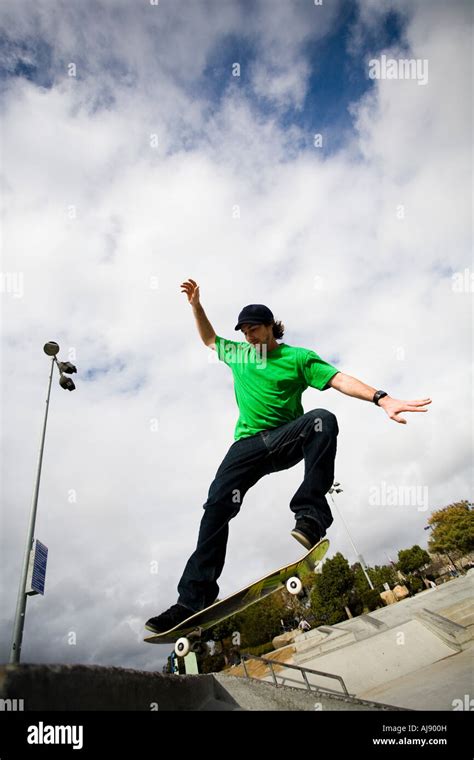 A skateboarder does a trick in mid air Stock Photo - Alamy