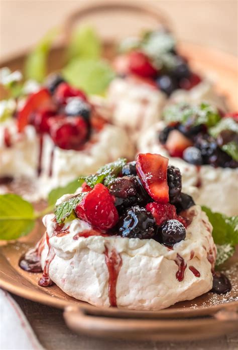 MINI PAVLOVAS topped with fresh fruit, whipped cream, and fruit syrup | Pavlova recipe, Mini ...