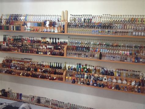 the shelves are filled with many different kinds of liquor