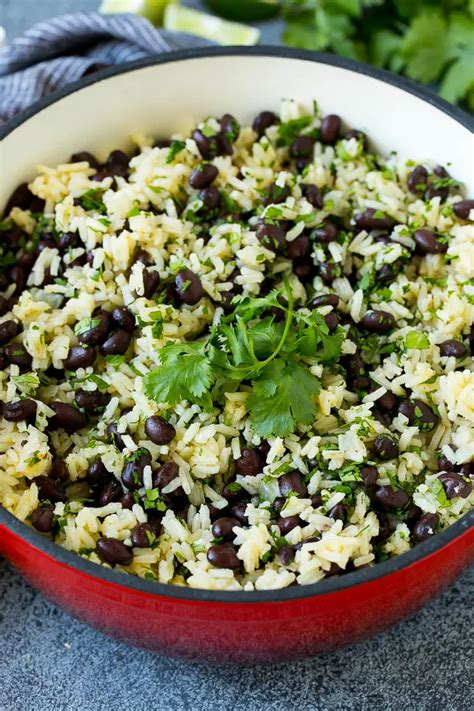 Black beans and rice in a pot topped with cilantro sprigs. | Rice and ...