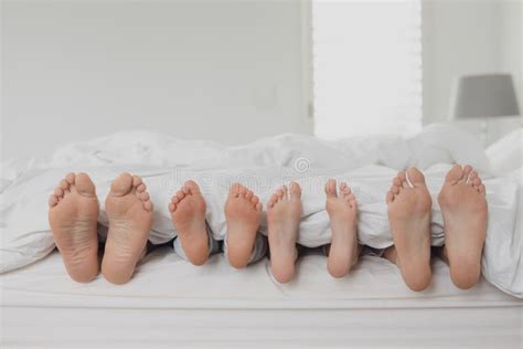 Family s feet in the bed stock image. Image of woman - 18108169