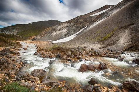 Premium Photo | Stream flowing by mountains at landmannalaugar in winter