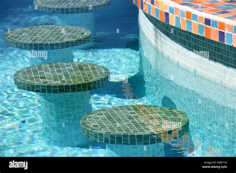 Colourful mosaic bar stools in a swimming pool Stock Photo - Alamy