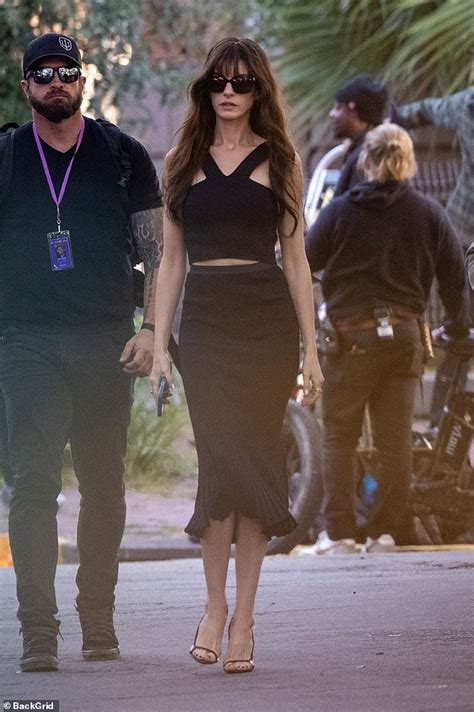 Anne Hathaway shows off sliver of her toned tummy in sexy black ensemble as she films The Idea ...