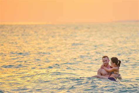 Man and Woman Swimming in a Beach · Free Stock Photo