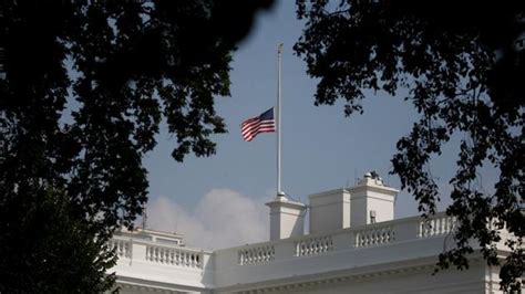 Trump relents under pressure, lowers White House flag again to honour ...