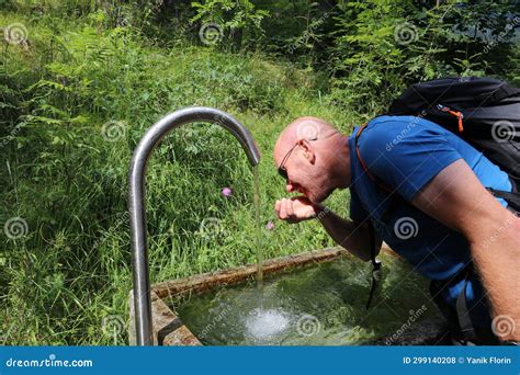 Man at a Fountain Drinking Spring Water Out of His Cupped Hand Stock ...