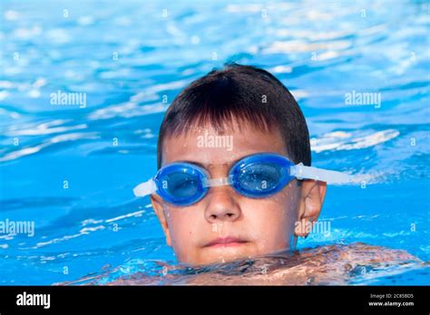 The boy floats in pool Stock Photo - Alamy