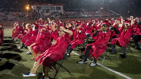 Harrison High School seniors finish graduation ceremony in a rainstorm