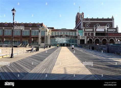 Visitors on Asbury Park Beach boardwalk with Convention Hall in the background.Asbury Park.New ...