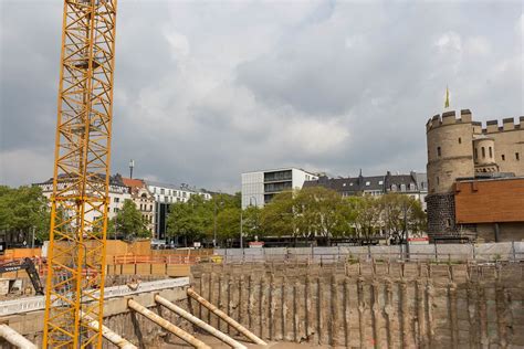Construction with crane and excavator at Rudolfplatz in Cologne with the medieval city wall in ...