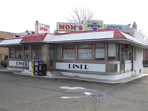 an old diner with signs on the roof