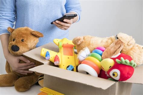 Volunteer Holding Donation Box with Old Toys. Stock Image - Image of drive, brown: 123514001