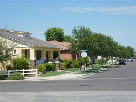 Tree lined street in Agritopia in Gilbert, AZ. Agritopia is a family ...