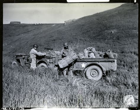 Soldiers unloading bed rolls belonging at Camp San Luis Obispo ...