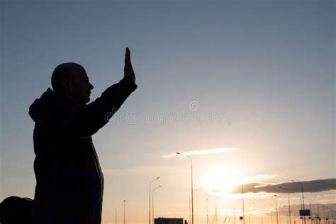 Silhouette of Middle Aged Man Waving His Hand Standing Alone at the Morning. Stock Photo - Image ...