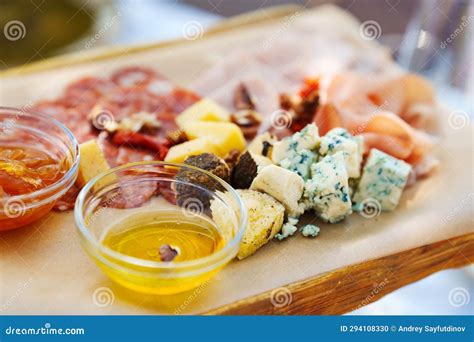 Wooden Tray with Assorted Meats and Cheeses with Sauces. Stock Photo - Image of restaurant ...