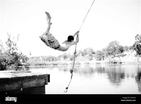 Boy rope swing lake Black and White Stock Photos & Images - Alamy