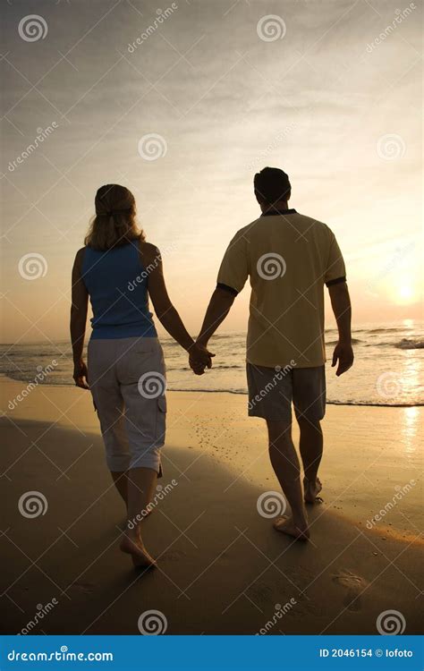 Couple Walking On Beach Stock Images - Image: 2046154