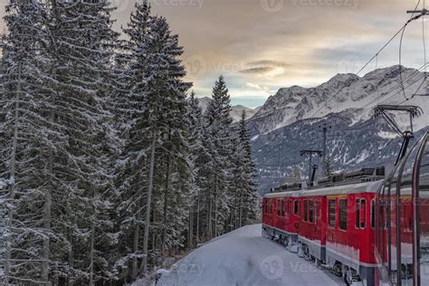 Red train in the snow in swiss alps 12010957 Stock Photo at Vecteezy