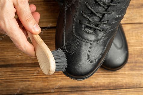 Premium Photo | Cleaning polishing restoration black leather boots with ...