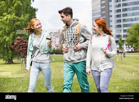 Young friends walking at college campus Stock Photo - Alamy