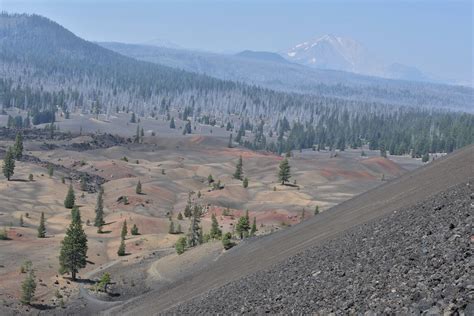 Cinder Cone, The Painted Dunes, and a smoky Mount Lassen in the background; Lassen National Park ...