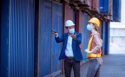 Premium Photo | Portrait team dock workers posing under working and checking production process ...