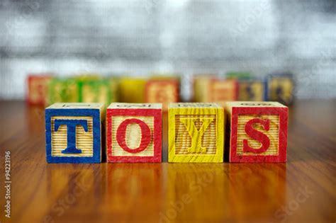 "Word of TOYS spelled with colorful wooden alphabet blocks.Selective focus,shallow depth of ...